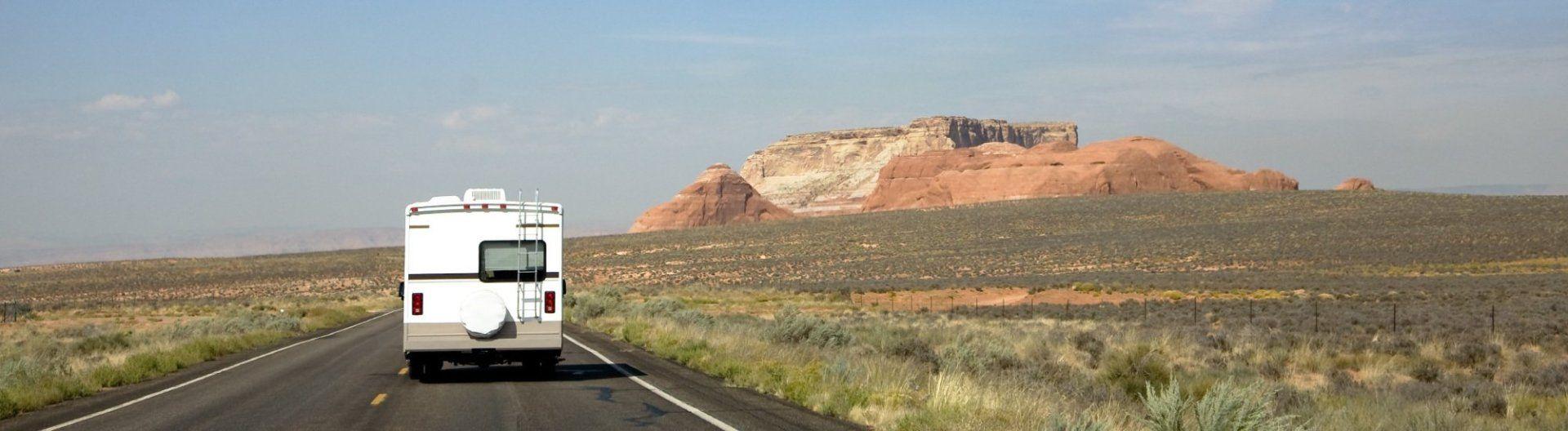 RV driving a desert-like open road
