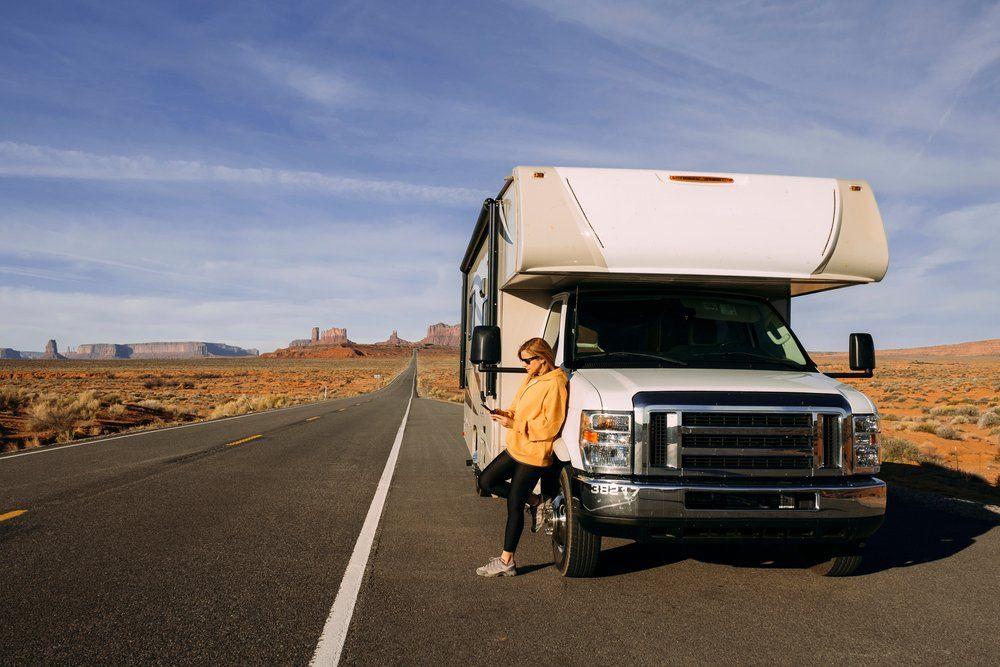 RV owner beside her parked recreational vehicle